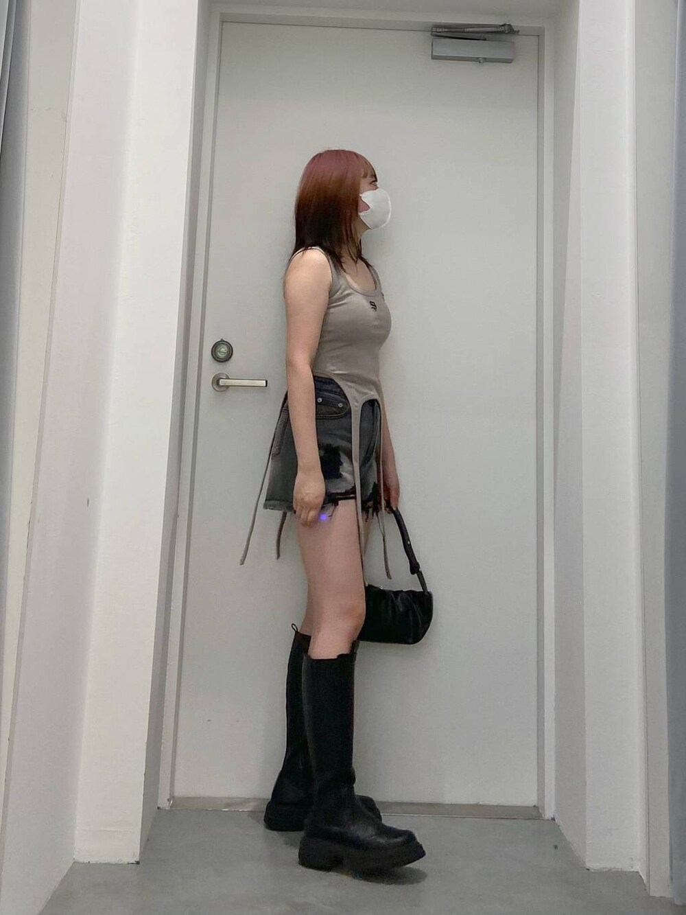 ブラック系のトートバッグ、ブラック系のデニムパンツを着用したレディースの春コーディネートの3枚目の写真