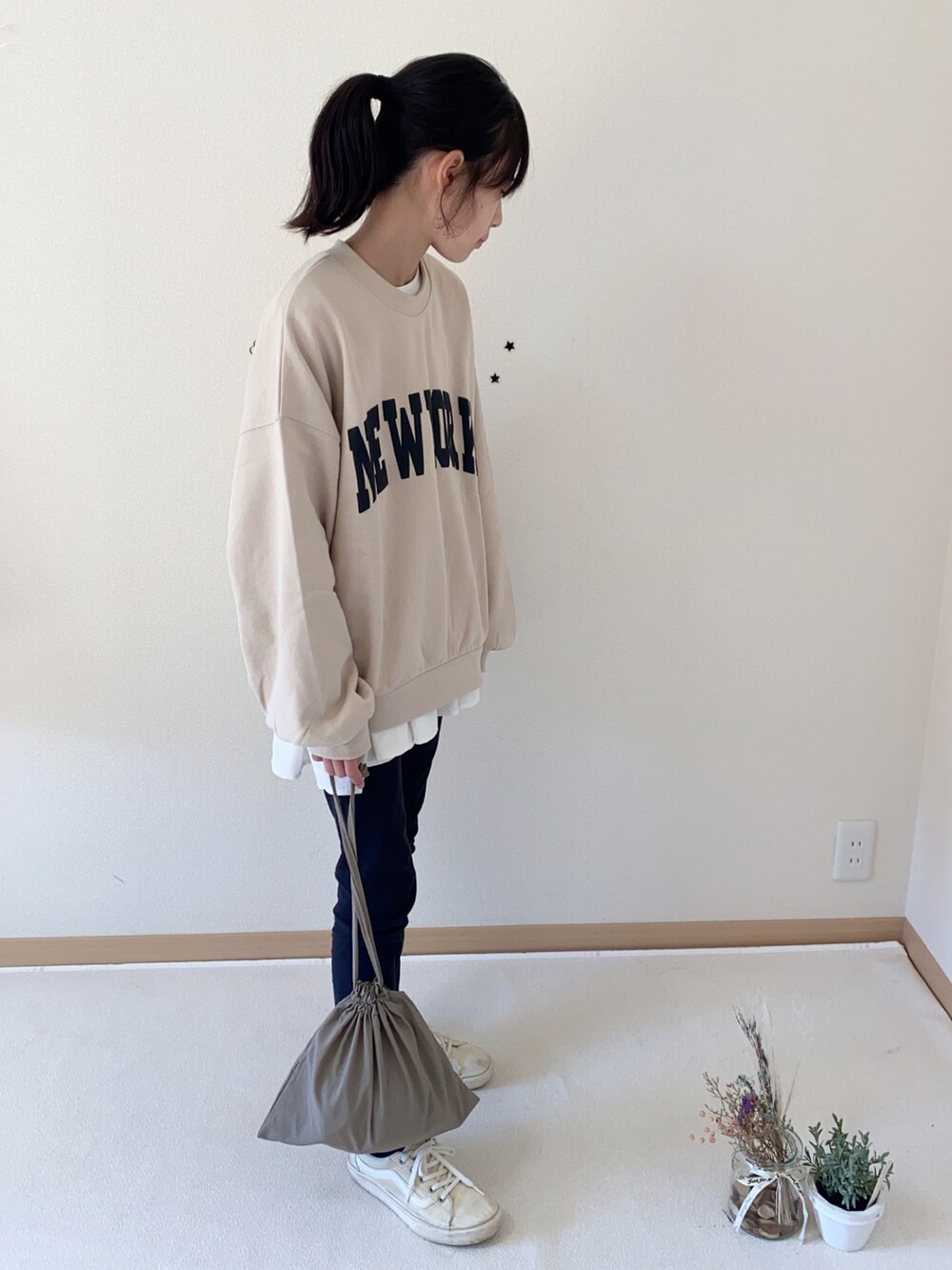 ブラック系のパンツ、ホワイト系のシャツ/ブラウス、ブラウン系のバッグを着用したキッズの秋コーディネートの3枚目の写真