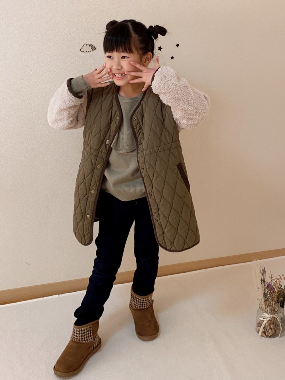 グリーン系のジャケット/アウター、グリーン系のニット/セーター、ブルー系のデニムパンツを着用したキッズの冬コーディネートの2枚目の写真