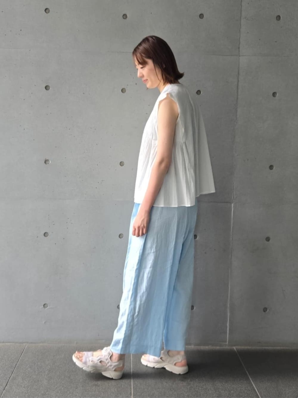 ホワイト系のシャツ/ブラウス、ブルー系のその他パンツ、グリーン系のネックレスを着用したレディースの夏コーディネートの2枚目の写真