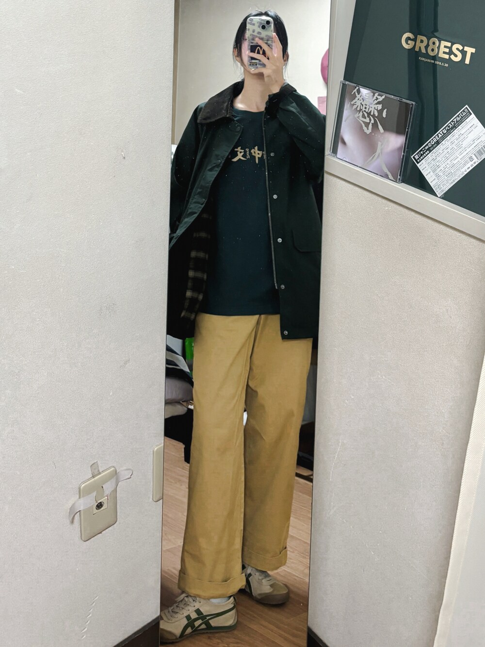 グリーン系のTシャツ/カットソーを着用したレディースの秋コーディネートの3枚目の写真