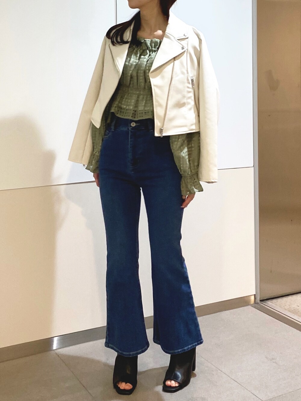 グリーン系のシャツ/ブラウス、ブルー系のデニムパンツ、ブラック系のショルダーバッグを着用したレディースの冬コーディネートの6枚目の写真