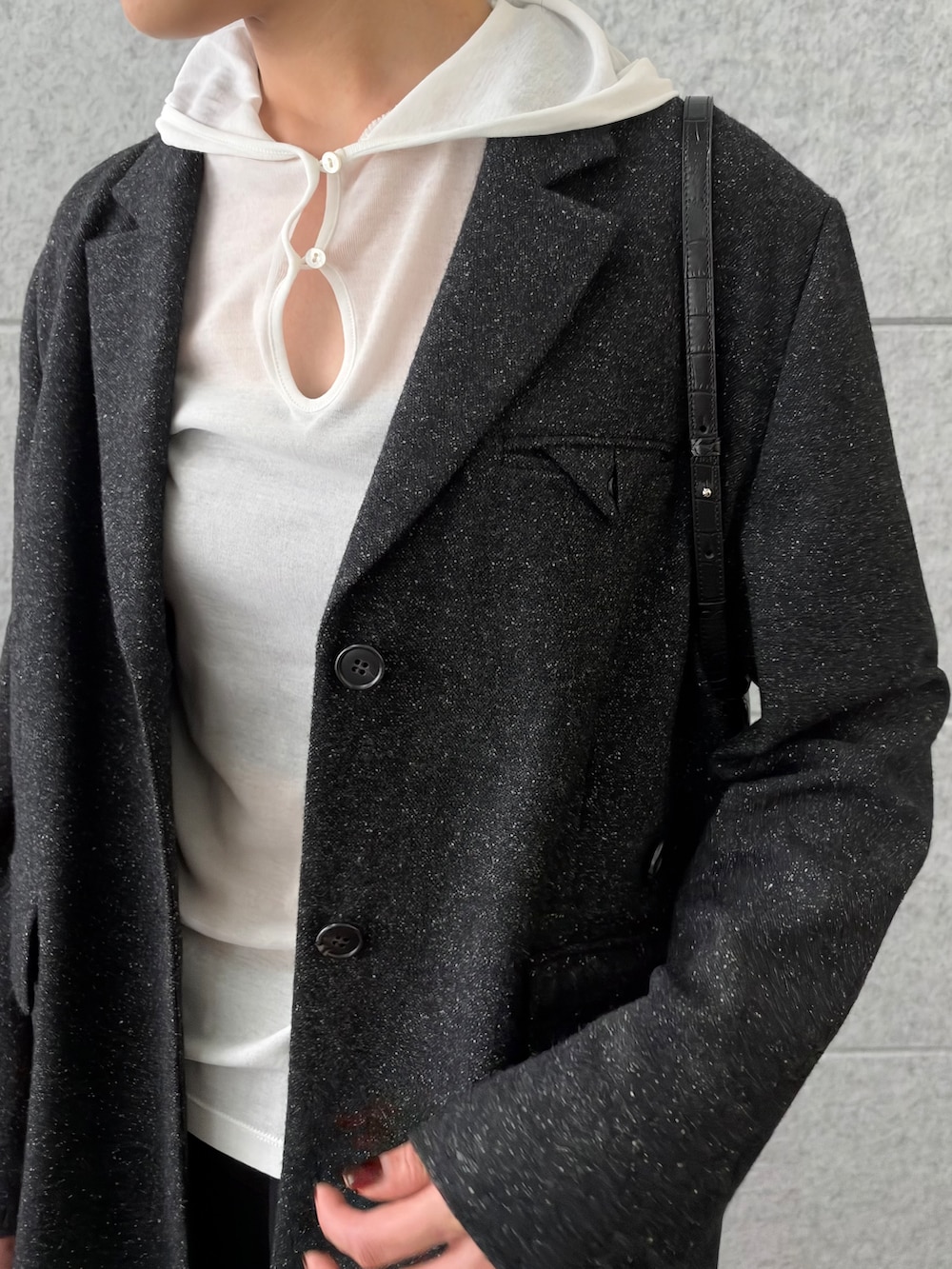 ブラック系のその他パンツ、ホワイト系のニット/セーター、ブラック系のテーラードジャケットを着用したレディースの秋コーディネートの6枚目の写真