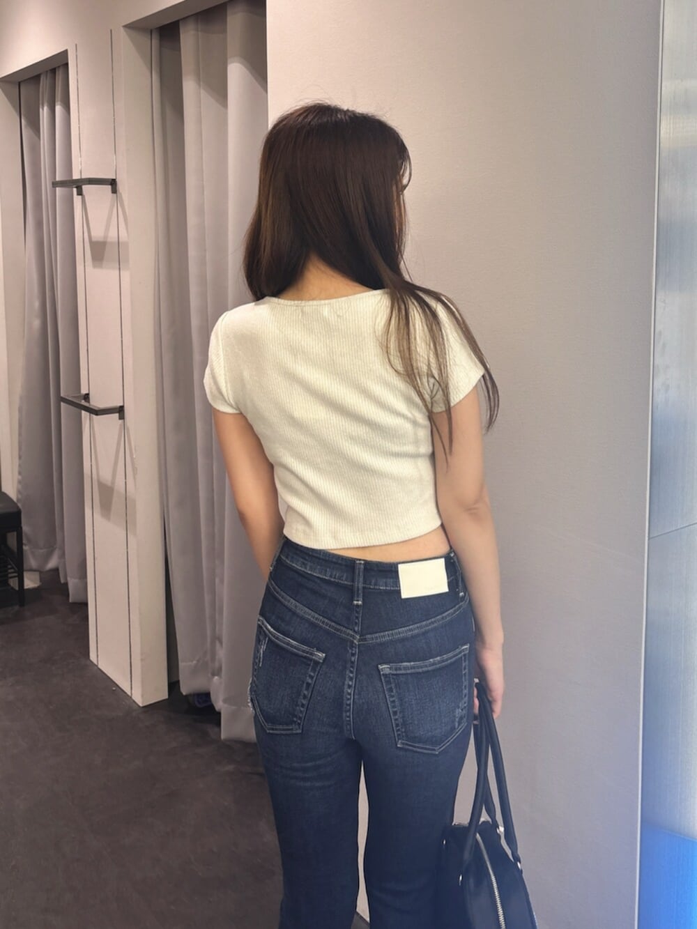 ブルー系のデニムパンツ、ホワイト系のサンダル、ホワイト系のTシャツ/カットソーを着用したレディースの夏コーディネートの6枚目の写真