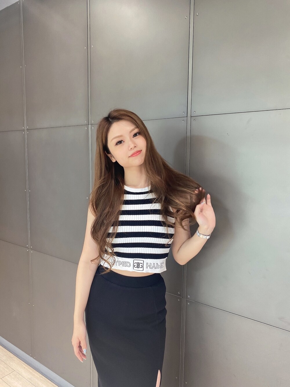 その他のタンクトップ、ブラック系のスカート、ホワイト系のサンダルを着用したレディースの夏コーディネートの4枚目の写真