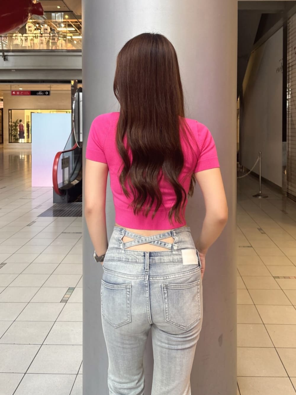 ブルー系のデニムパンツ、ホワイト系のサンダル、ピンク系のニット/セーターを着用したレディースの夏コーディネートの6枚目の写真