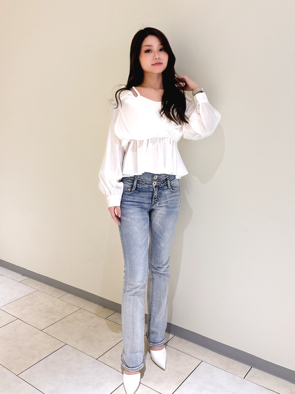 ホワイト系のシャツ/ブラウス、ブルー系のデニムパンツ、ホワイト系のパンプスを着用したレディースの冬コーディネートの3枚目の写真