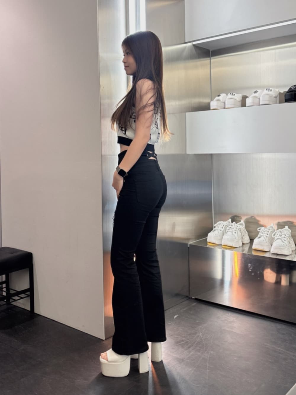 ブルー系のデニムパンツ、ホワイト系のサンダル、ピンク系のタンクトップを着用したレディースの夏コーディネートの2枚目の写真