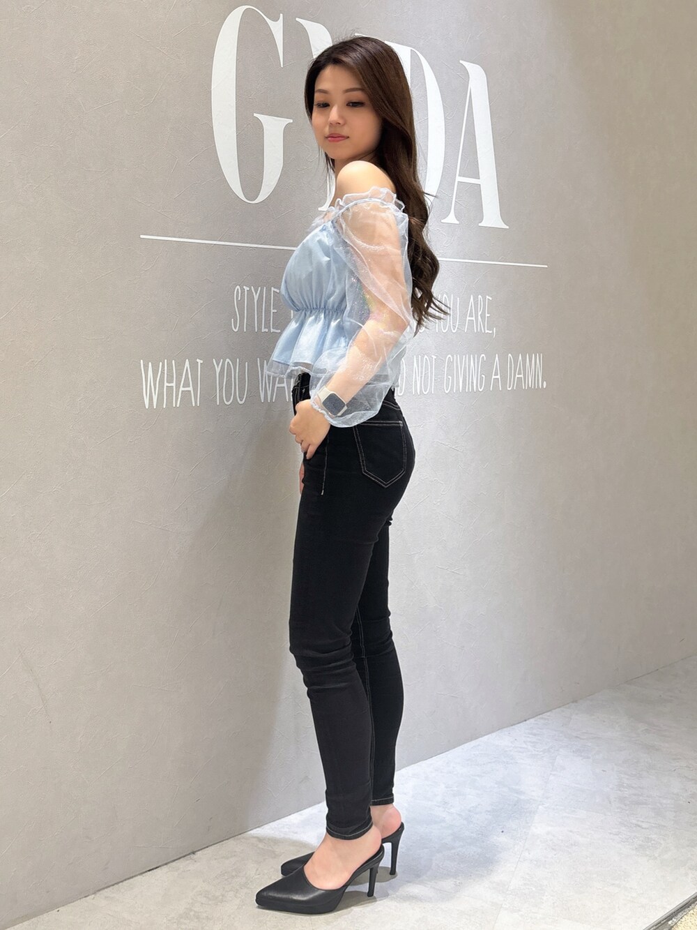 ブルー系のシャツ/ブラウス、ブラック系のデニムパンツ、ホワイト系のパンプスを着用したレディースの春コーディネートの2枚目の写真