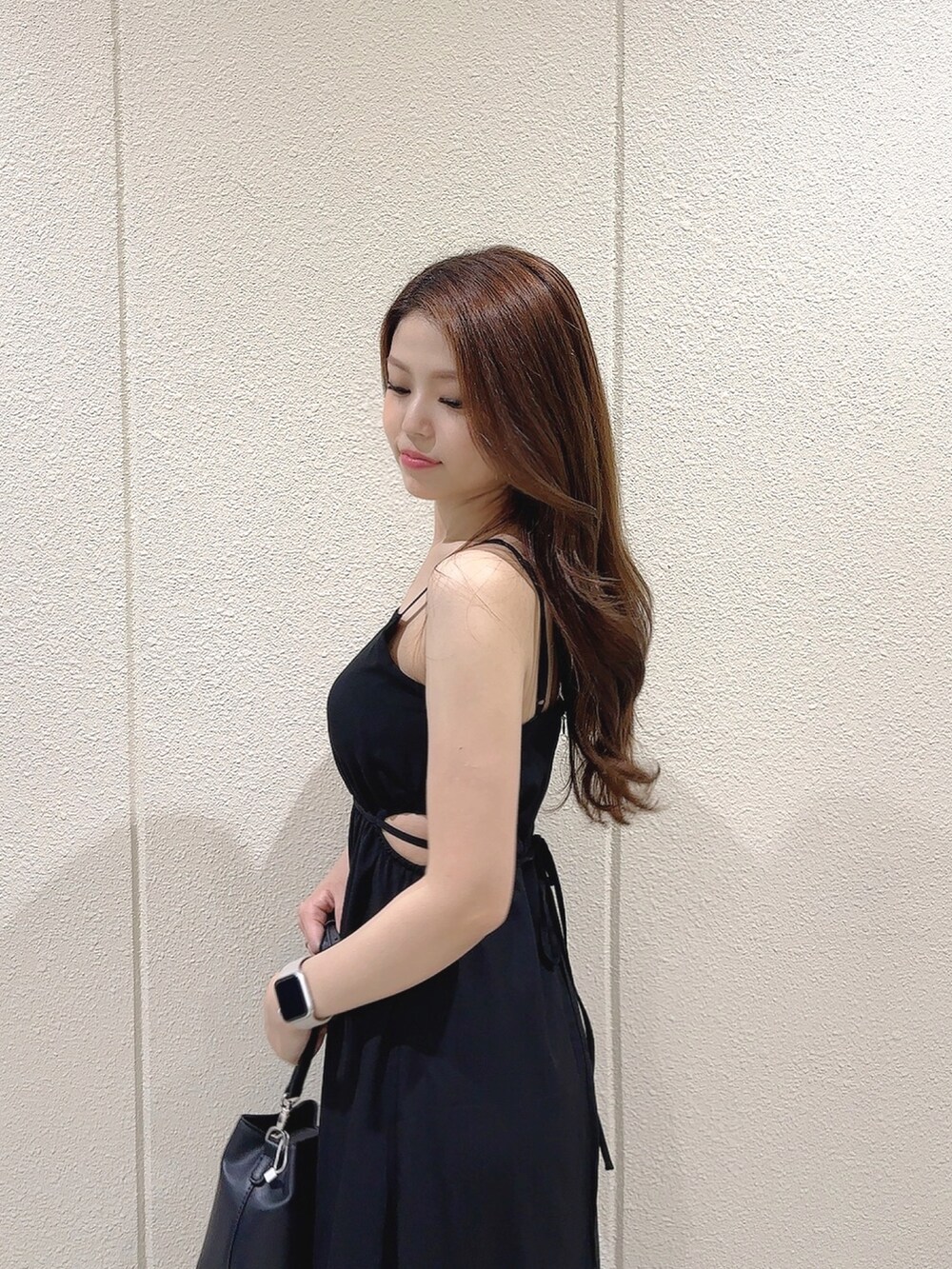 ブラック系のワンピース、ブラック系のショルダーバッグ、ホワイト系のサンダルを着用したレディースの夏コーディネートの7枚目の写真