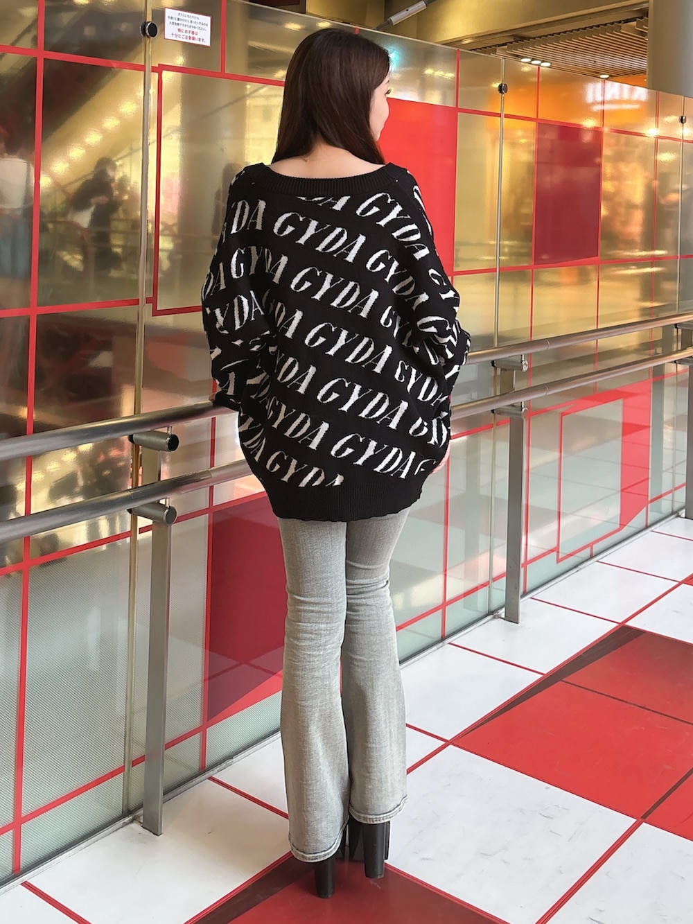 ブラック系のカーディガン/ボレロ、ホワイト系のキャミソール、ブルー系のデニムパンツを着用したレディースの春コーディネートの3枚目の写真