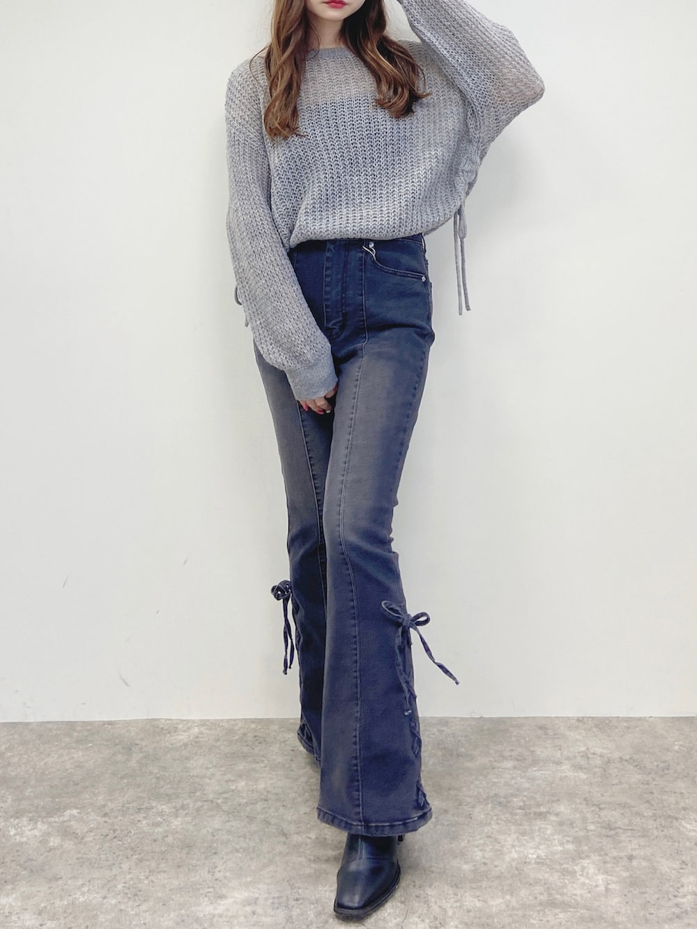 グレー系のデニムパンツ、グレー系のニット/セーターを着用したレディースの秋コーディネートの3枚目の写真