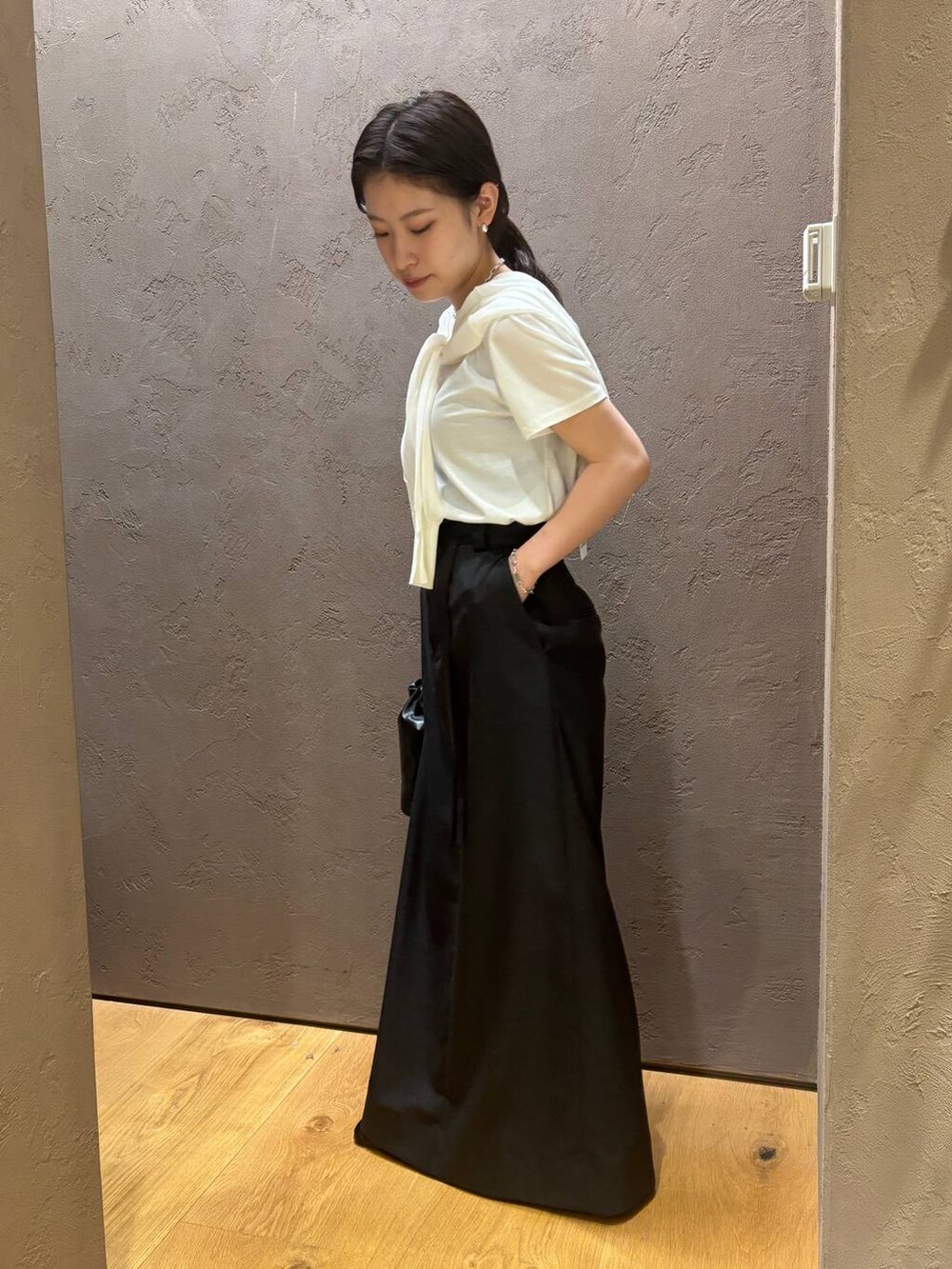 ホワイト系のTシャツ/カットソー、ホワイト系のカーディガン/ボレロ、グレー系のスカートを着用したレディースの夏コーディネートの3枚目の写真