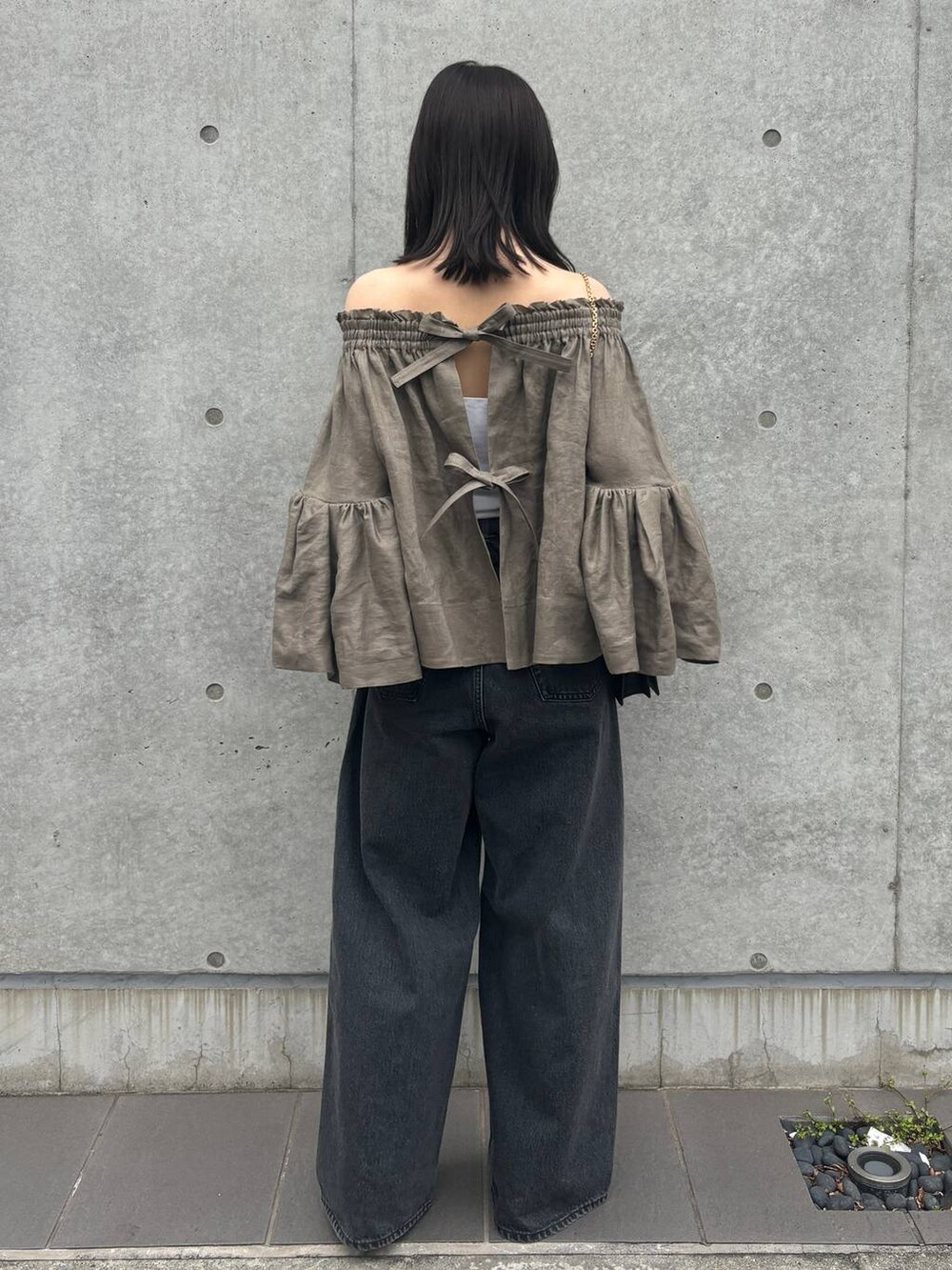 ブラック系のデニムパンツ、グリーン系のシャツ/ブラウスを着用したレディースの春コーディネートの3枚目の写真