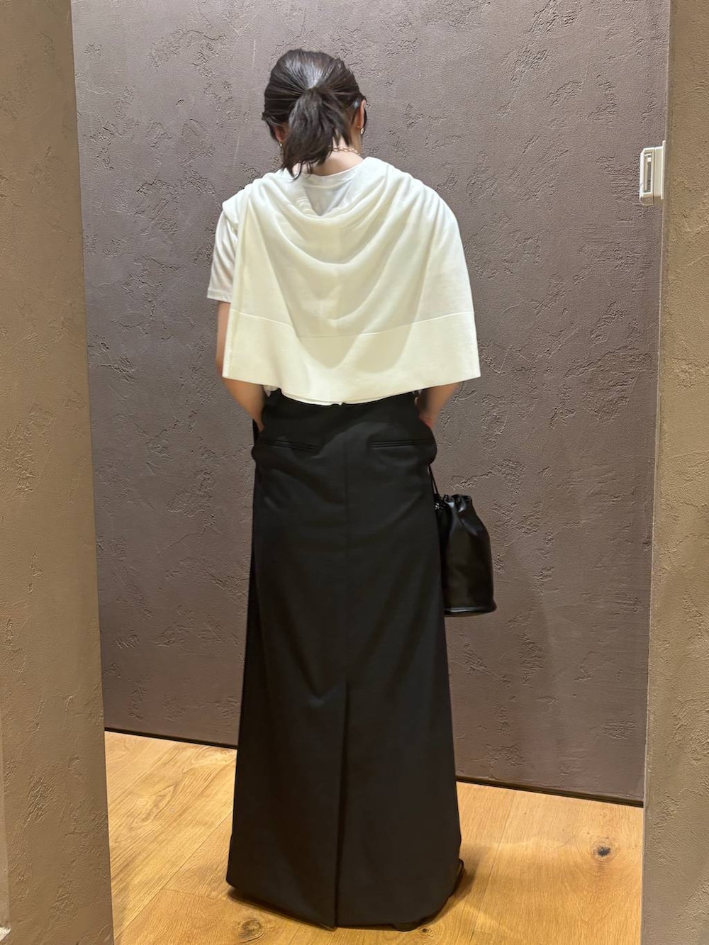 ホワイト系のTシャツ/カットソー、ホワイト系のカーディガン/ボレロ、グレー系のスカートを着用したレディースの夏コーディネートの4枚目の写真