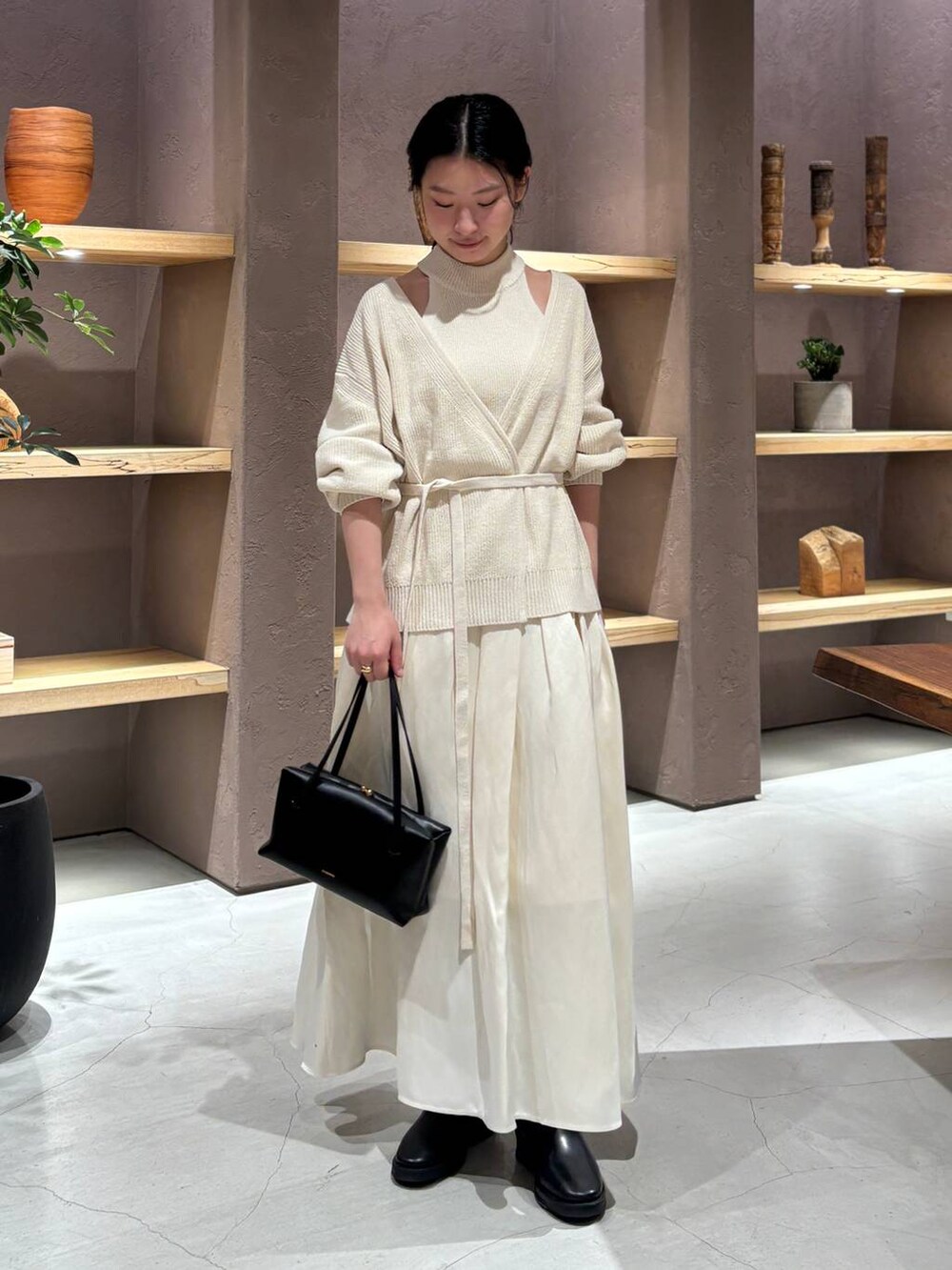 ホワイト系のカーディガン/ボレロ、ホワイト系のタンクトップ、ホワイト系のスカートを着用したレディースの冬コーディネートの2枚目の写真