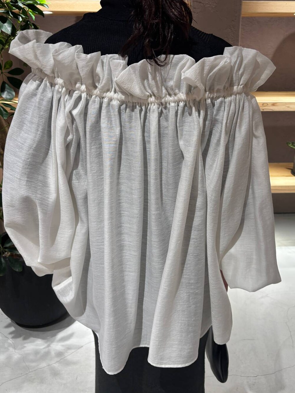 ブラック系のニット/セーター、グリーン系のスカートを着用したレディースの秋コーディネートの6枚目の写真