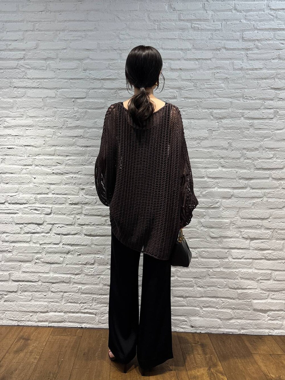 ブラック系のその他パンツ、ブラック系のタンクトップ、ブラウン系のニット/セーターを着用したレディースの春コーディネートの3枚目の写真
