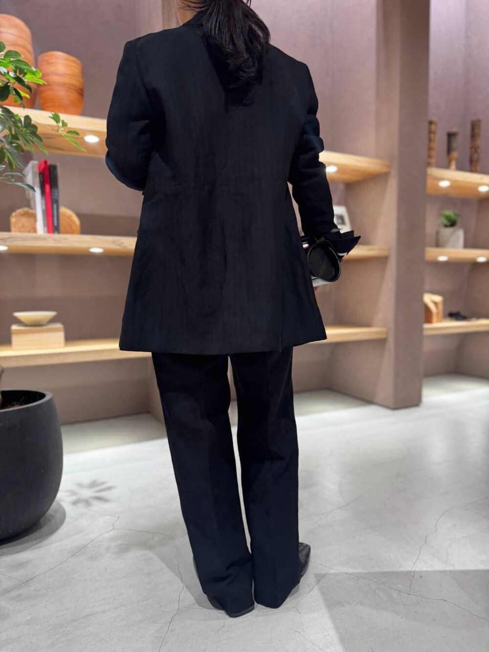 ブラック系のスラックス、ブラック系のテーラードジャケット、グレー系のカーディガン/ボレロを着用したレディースの冬コーディネートの7枚目の写真