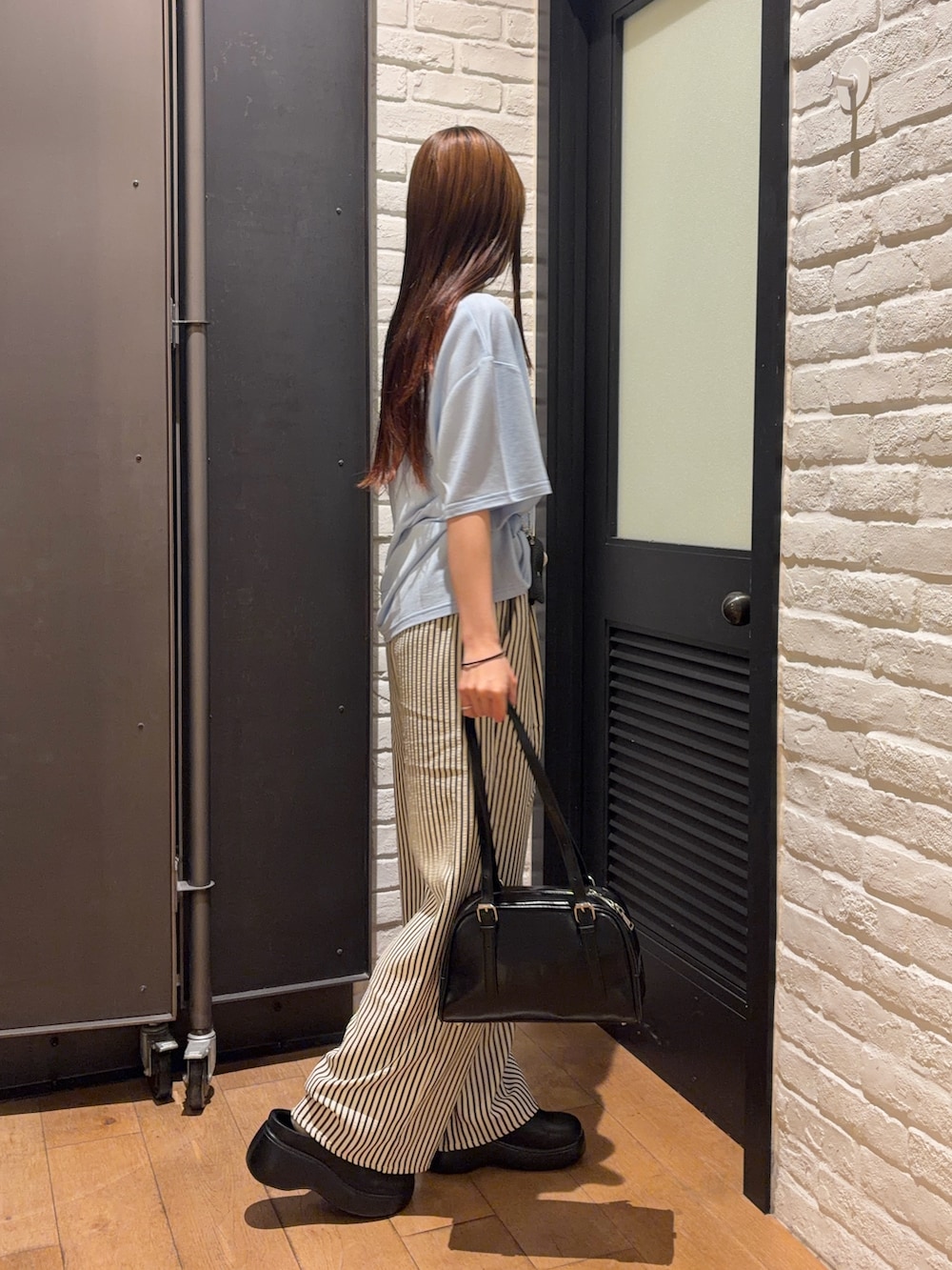 ブルー系のその他パンツ、ブラック系のボストンバッグ、ブラック系のサンダルを着用したレディースの夏コーディネートの4枚目の写真