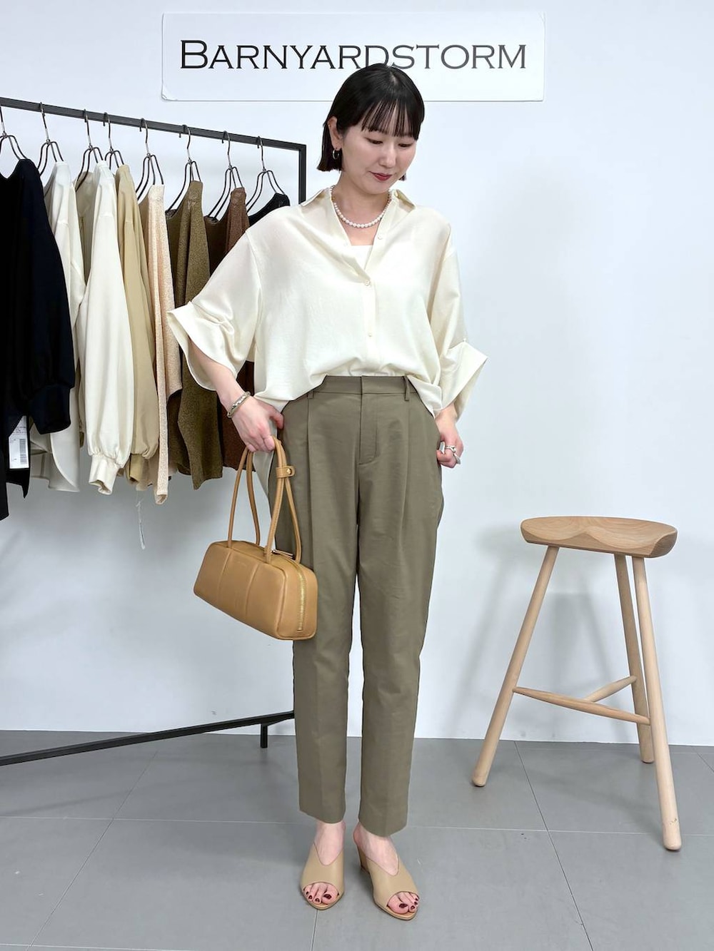 イエロー系のボストンバッグ、グリーン系のその他パンツ、ホワイト系のシャツ/ブラウスを着用したレディースの春コーディネートの3枚目の写真