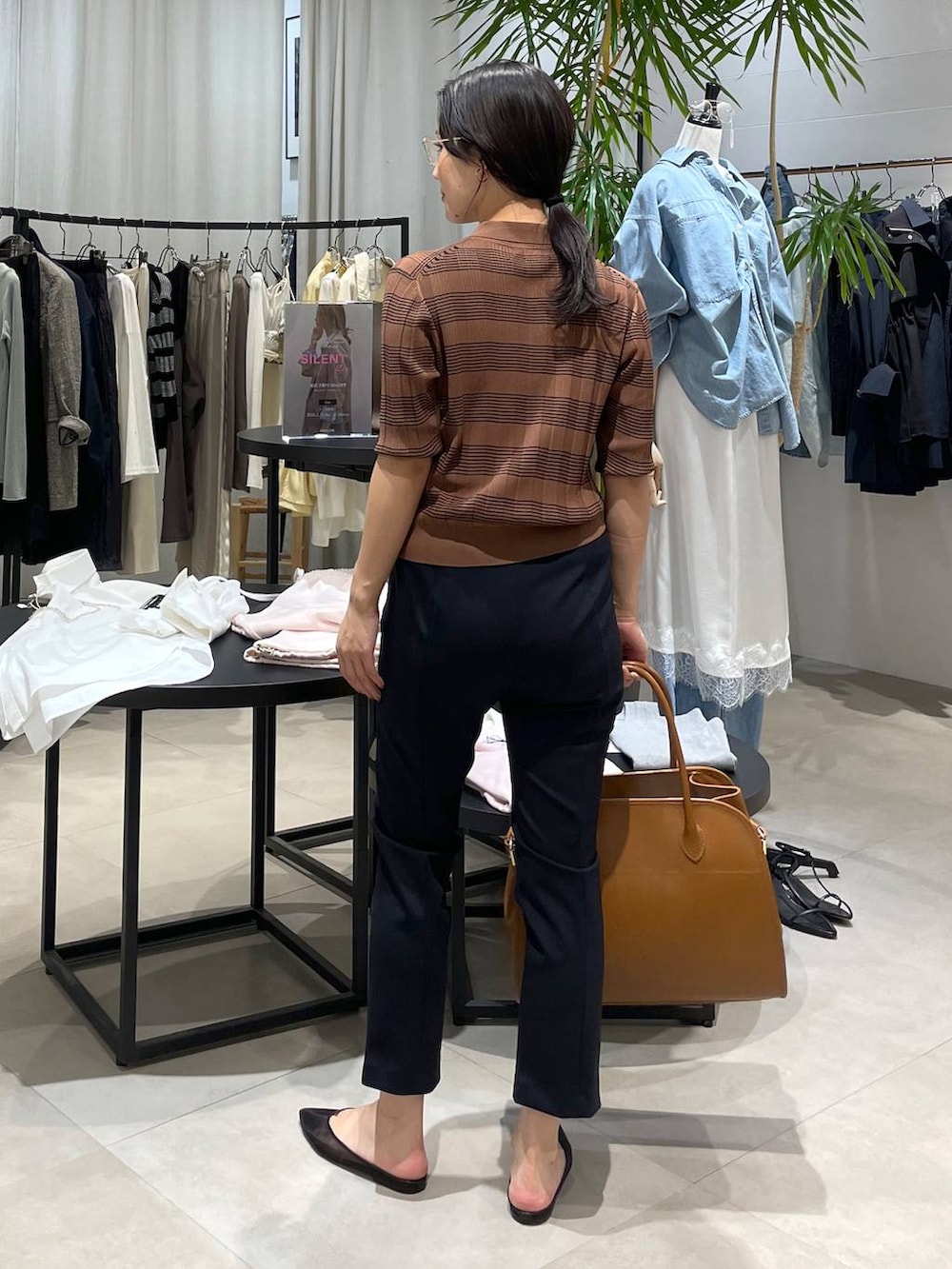 ブラック系のパンプス、ブラウン系のボストンバッグ、ブラック系のその他パンツを着用したレディースの春コーディネートの5枚目の写真