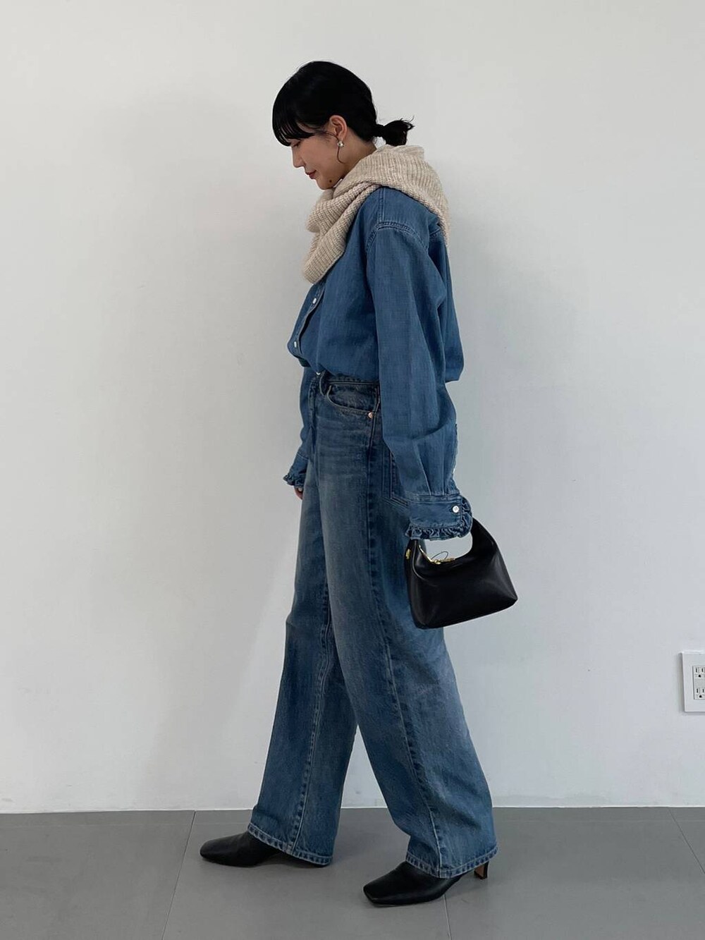 ブルー系のデニムパンツ、ブルー系のシャツ/ブラウス、ホワイト系のマフラーを着用したレディースの冬コーディネートの3枚目の写真