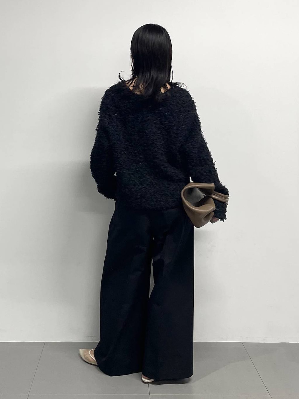 ベージュ系のパンプス、ブラック系のノーカラージャケット、ブラック系のチノパンツを着用したレディースの冬コーディネートの4枚目の写真