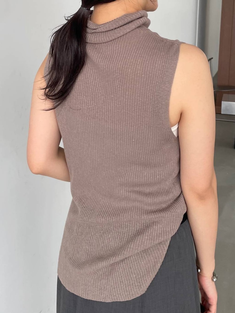 ブラック系のショルダーバッグ、ブラウン系のニット/セーター、グレー系のその他パンツを着用したレディースの夏コーディネートの4枚目の写真