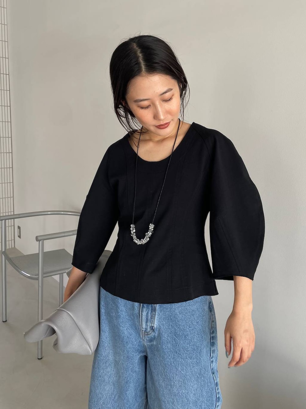 ブルー系のデニムパンツ、ブラック系のTシャツ/カットソー、グレー系のショルダーバッグを着用したレディースの春コーディネートの7枚目の写真