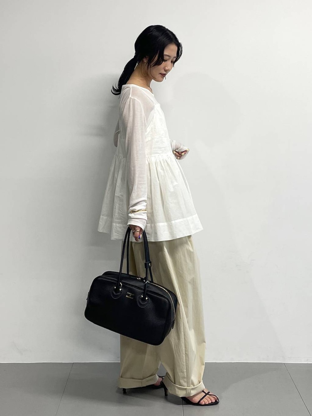 ブラック系のサンダル、ホワイト系のTシャツ/カットソー、ホワイト系のキャミソールを着用したレディースの春コーディネートの3枚目の写真