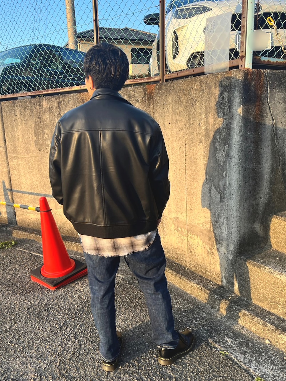 ホワイト系のシャツ/ブラウス、ブラック系のブーツ、ブラック系のブルゾンを着用したメンズの春コーディネートの2枚目の写真