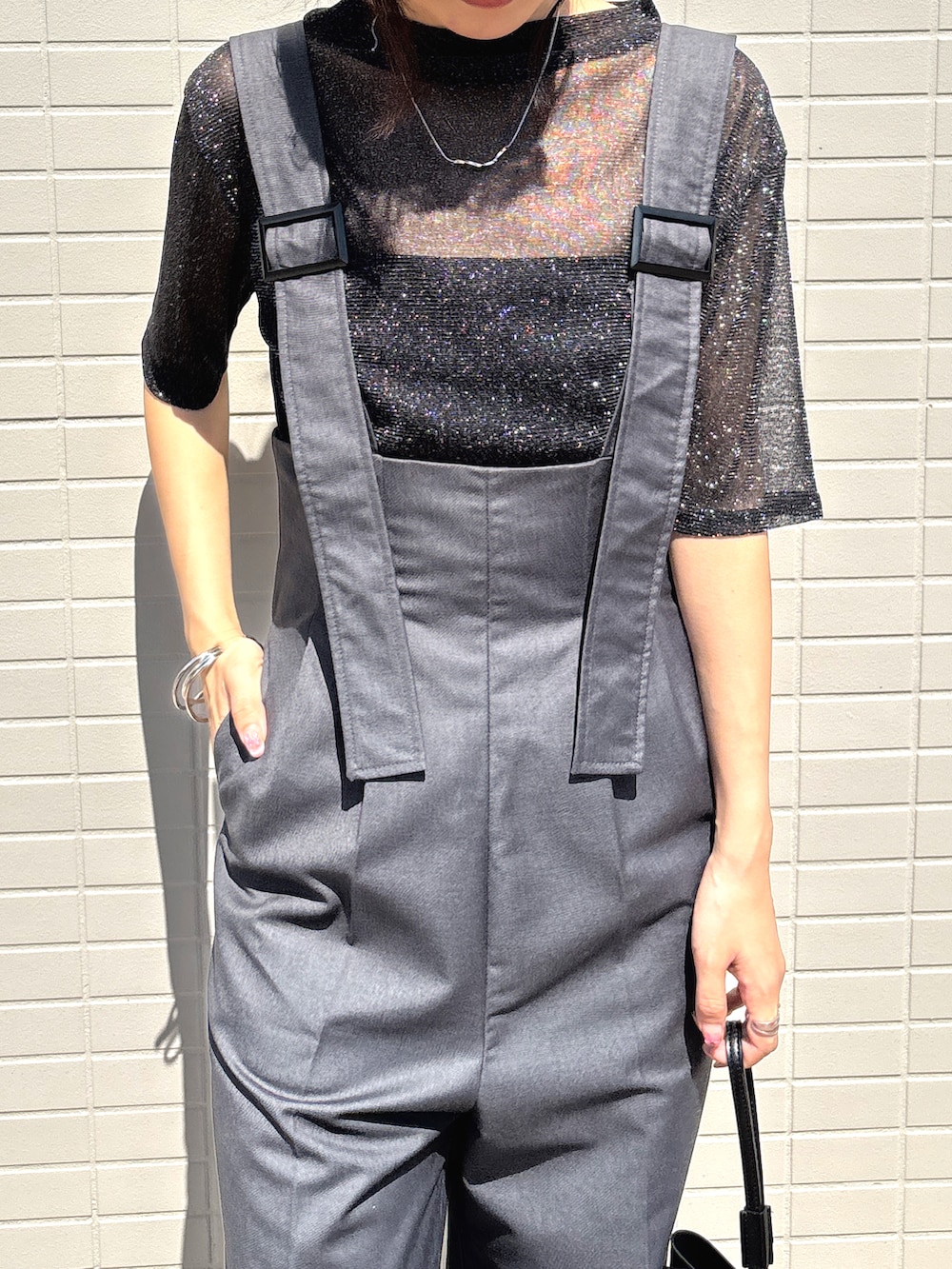 ブラック系のTシャツ/カットソー、グレー系のサロペット/オーバーオールを着用したレディースの春コーディネートの2枚目の写真