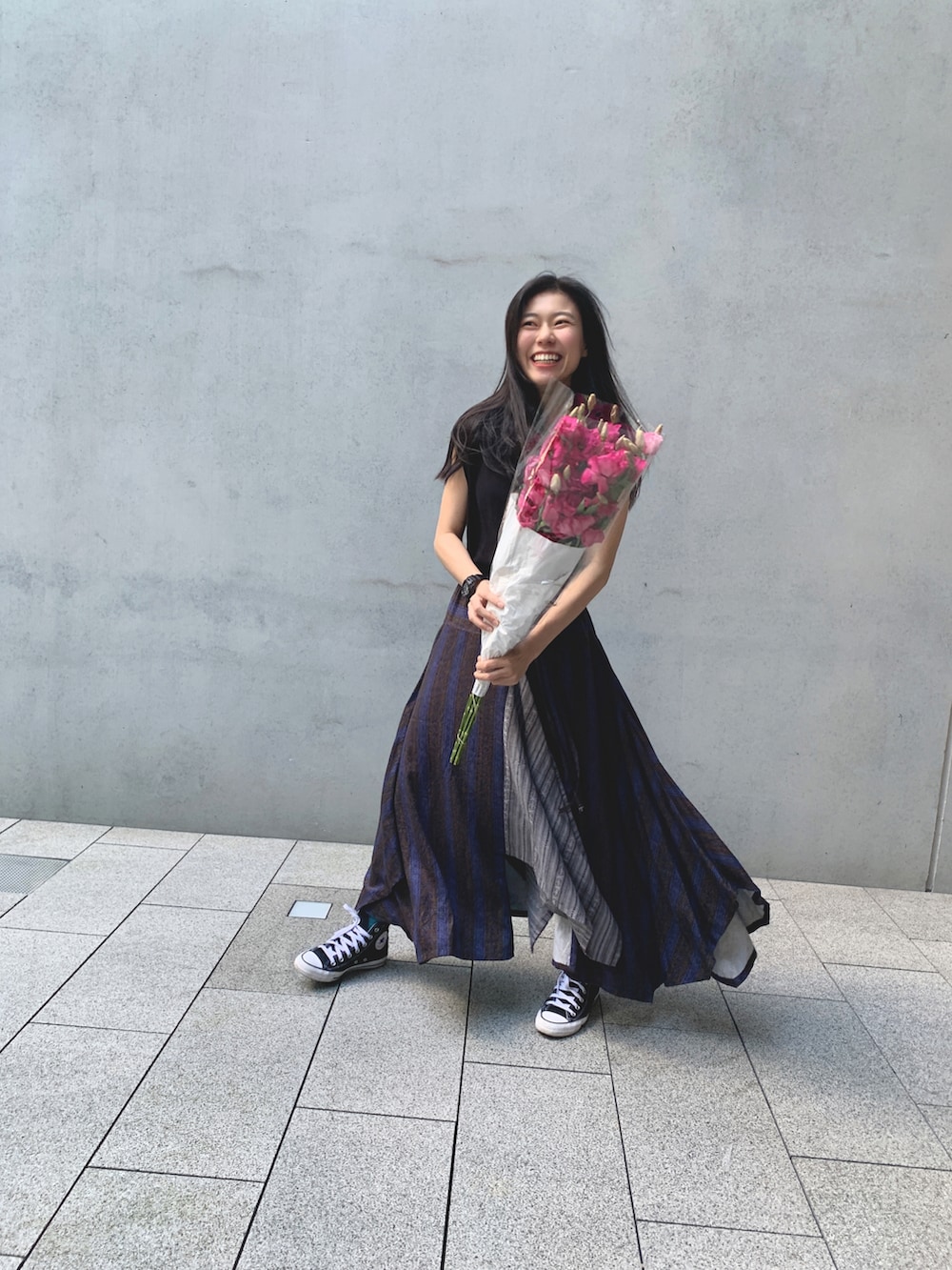 パープル系のスカートを着用したレディースの秋コーディネートの3枚目の写真