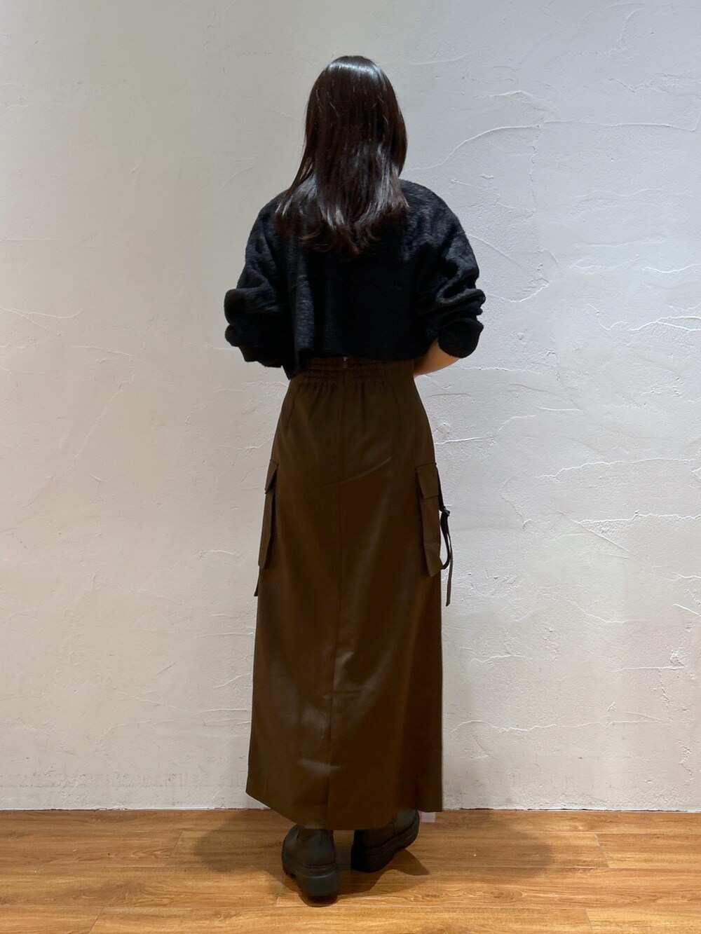 ブラック系のカーディガン/ボレロ、ブラウン系のスカート、オレンジ系のショルダーバッグを着用したレディースの秋コーディネートの3枚目の写真