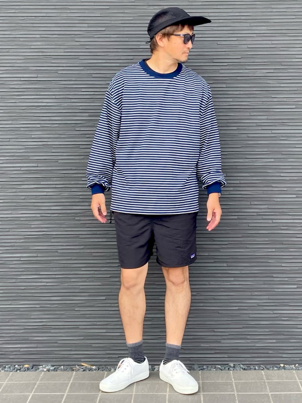 ブルー系のTシャツ/カットソー、ブラック系のその他パンツ、ホワイト系のスニーカーを着用したメンズの春コーディネートの2枚目の写真