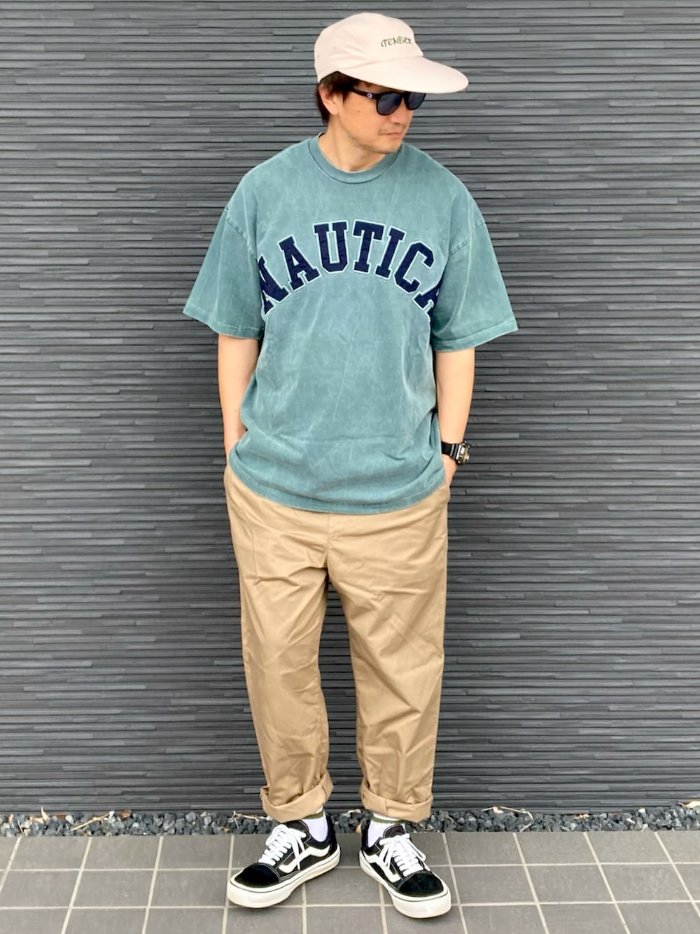 グリーン系のTシャツ/カットソー、ベージュ系のその他パンツ、ブラック系のスニーカーを着用したメンズの夏コーディネートの2枚目の写真