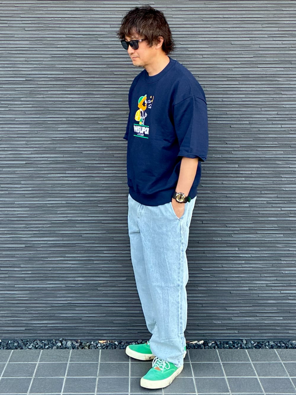 ブルー系のデニムパンツ、ブルー系のトップス、グリーン系のスニーカーを着用したメンズの春コーディネートの3枚目の写真
