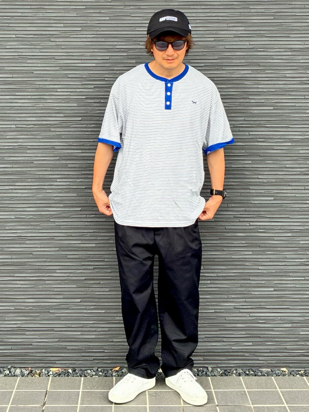 ブラック系のチノパンツ、ホワイト系のスニーカー、ブルー系のTシャツ/カットソーを着用したメンズの夏コーディネートの3枚目の写真