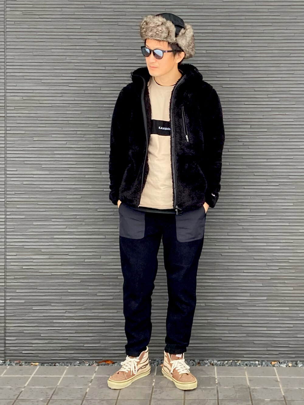 ブラック系のパーカー、ベージュ系のTシャツ/カットソー、ブラック系のパンツを着用したメンズの冬コーディネートの2枚目の写真