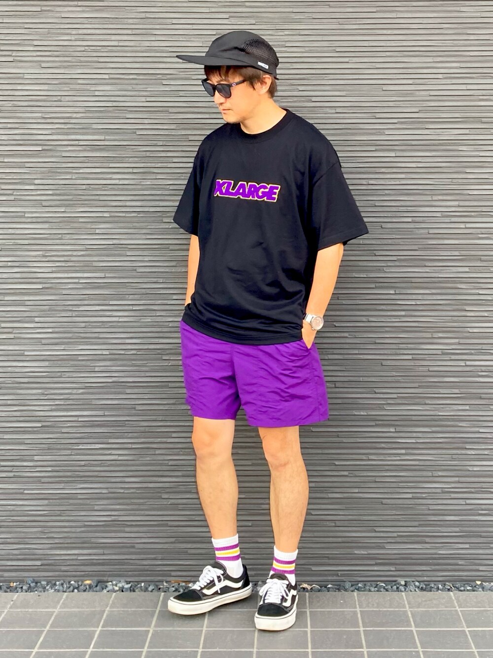 ブラック系のTシャツ/カットソー、パープル系のパンツ、ブラック系のスニーカーを着用したメンズの夏コーディネートの3枚目の写真