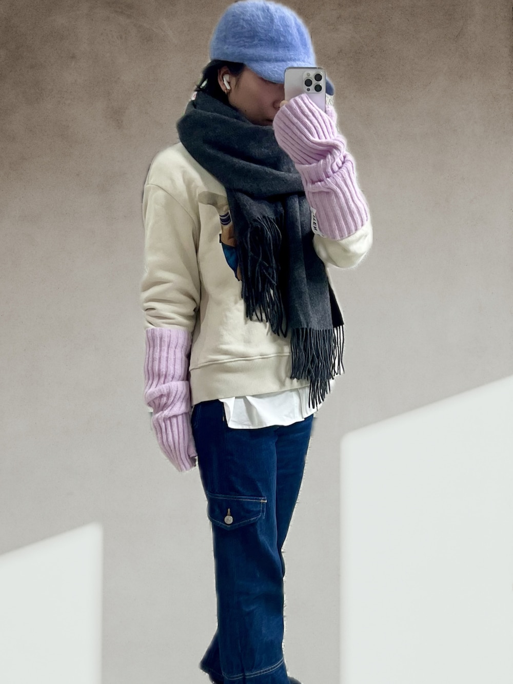 ブラック系のハンドバッグ、ブルー系のデニムパンツ、ブラック系のスニーカーを着用したレディースの春コーディネートの2枚目の写真