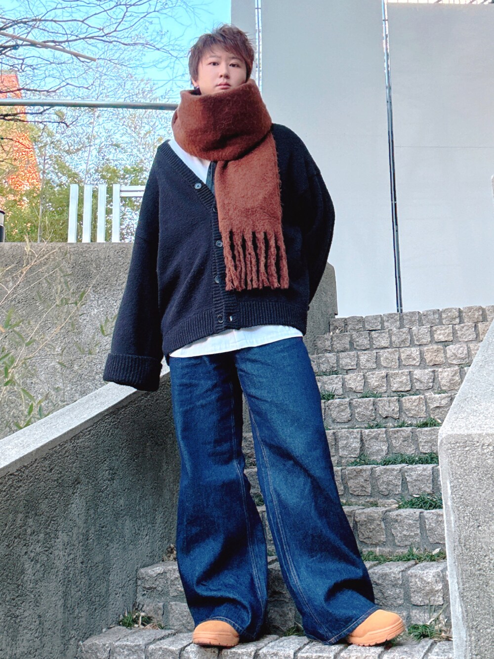 ブルー系のデニムパンツ、ブラック系のカーディガン/ボレロ、ホワイト系のシャツ/ブラウスを着用したメンズの冬コーディネートの2枚目の写真