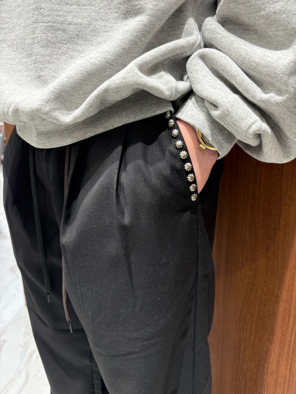 ブラック系のチノパンツ、グレー系のスウェットを着用したメンズの秋コーディネートの4枚目の写真