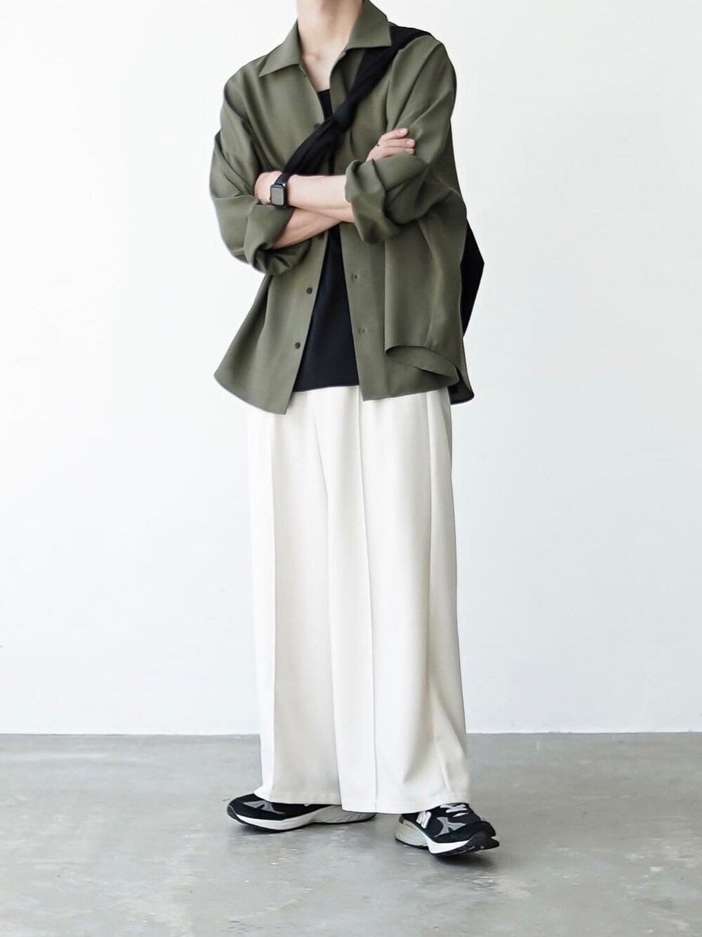 ブラック系のタンクトップ、ブラック系のスニーカー、ブラック系のショルダーバッグを着用したメンズの夏コーディネートの2枚目の写真