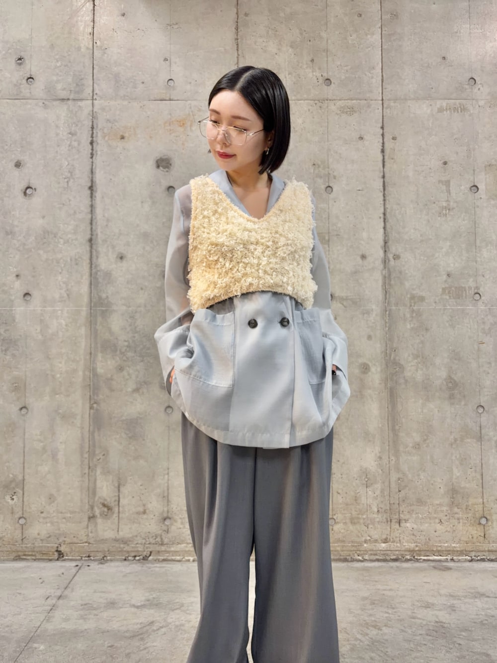 ブルー系のテーラードジャケット、グレー系のスラックス、ブラック系のパンプスを着用したレディースの春コーディネートの2枚目の写真