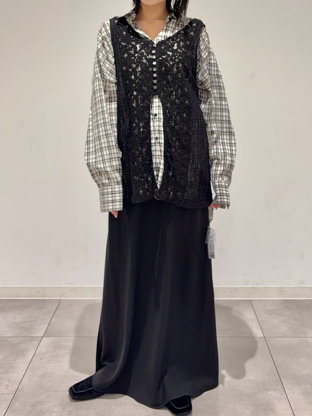 ブラック系のカーディガン/ボレロ、ホワイト系のシャツ/ブラウス、ブラック系のスカートを着用したレディースの秋コーディネートの3枚目の写真