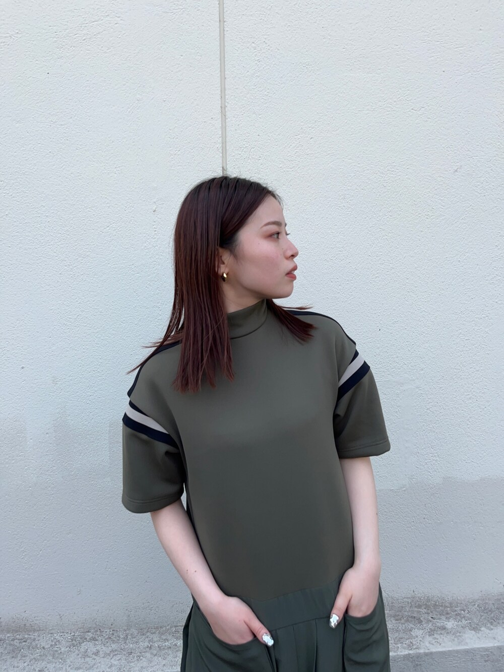 グリーン系のワンピースを着用したレディースの春コーディネートの4枚目の写真