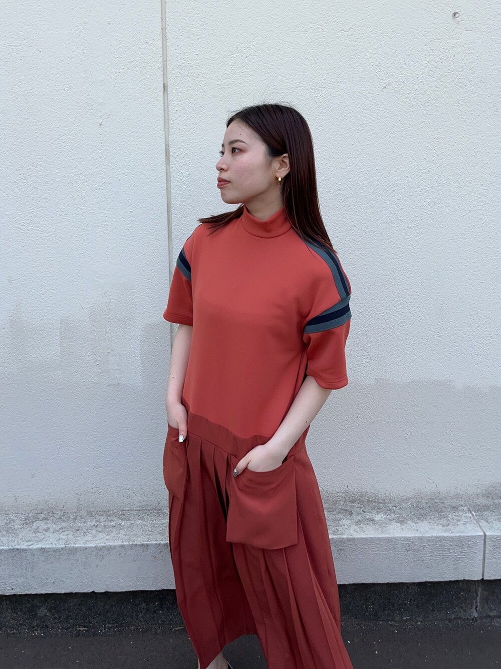 オレンジ系のワンピースを着用したレディースの春コーディネートの4枚目の写真