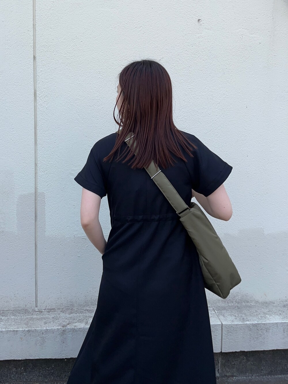 ブラック系のワンピース、グリーン系のトートバッグを着用したレディースの春コーディネートの5枚目の写真